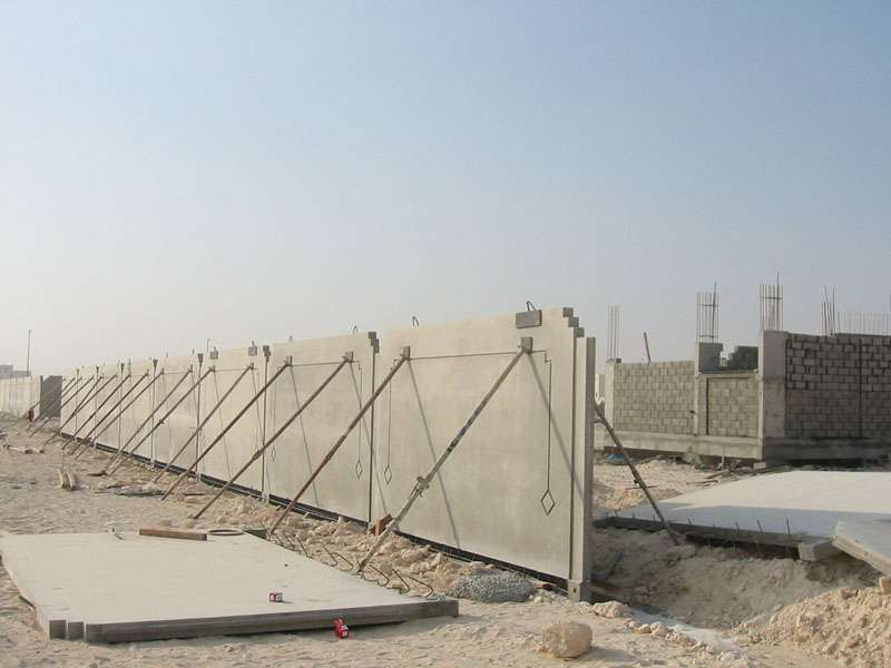 boundry-wall-gallery-1 Precast concrete boundary wall panels under construction with temporary support braces at building site