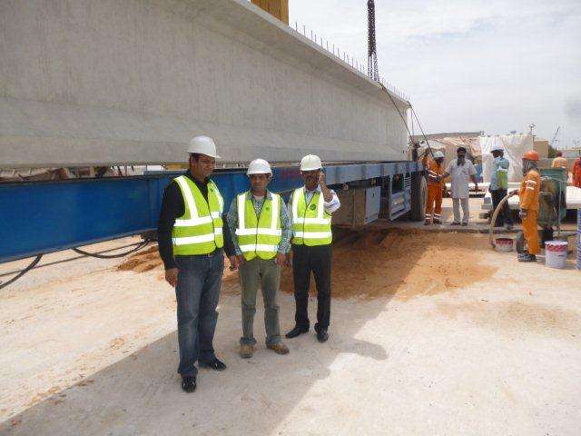 P1020003 engineers inspecting precast beam installation at building site with crane and safety equipment