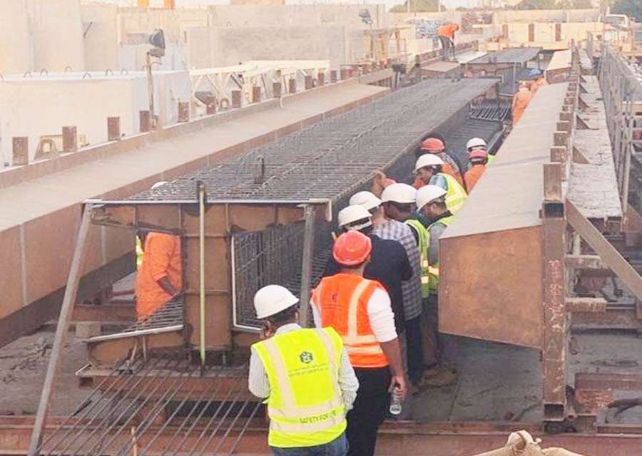 girder Engineers and workers inspecting reinforcement work for precast beams and columns.
